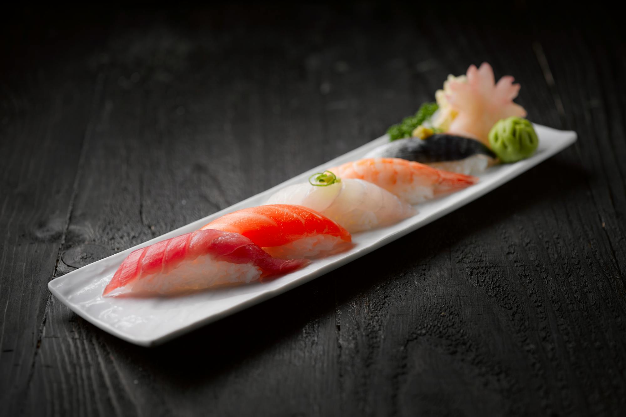 Nigiri placed on dark wood